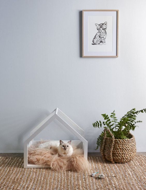 a house-shaped cat bed with faux fur is a stylish idea for a minimalist or Scandinavian interior