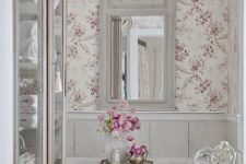 a cozy bathroom with a floral wallpaper