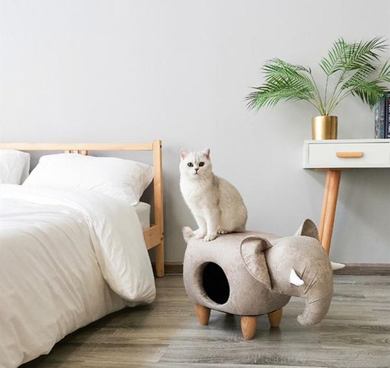 a neutral elephant cat bed that doubles as an ottoman is a cool and chic idea for a modern space