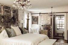 a neutral vintage bedroom with brick walls, shutters, a crystal chandelier and chic furniture plus artworks