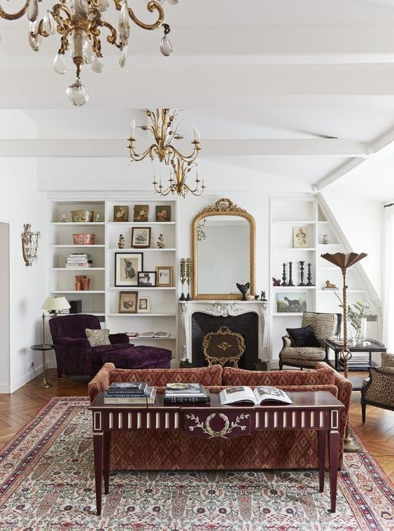 غرف معيشة كلاسيكية A-refined-vintage-living-room-with-a-printed-sofa-a-purple-lounger-leopard-chairs-a-fireplace-built-in-shelves-and-a-mirror-in-a-gilded-frame