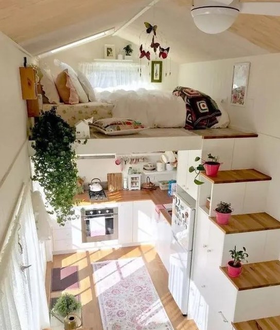 a small house with a loft bedroom and a storage stairs plus a kitchen down contains everything you may need for living