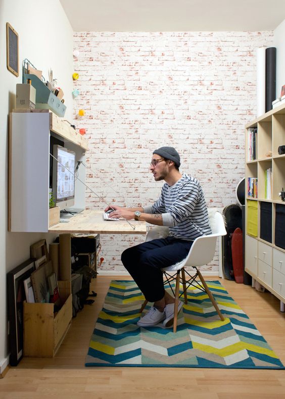 a storage unit with a built-in foldable desk and some organizers on top is ideal for a small space