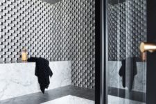 a stylish steam room clad with marble and mosaic tiles and with long benches along the walls