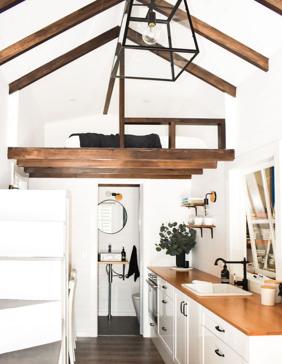 a tiny modern home with a loft bedroom that includes only a low bed and nothing else is a cool idea to get a separate sleeping space
