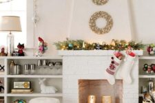 a white brick fireplace with gold mercury glass candle holders with pillar candles
