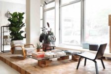 a wooden cube platform by the window is a gorgeous way to highlight the reading space