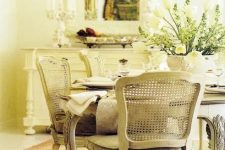 an elegant vintage or shabby chic dining space with a chic and stylish dining set, a vintage chandelier and some vintage furniture