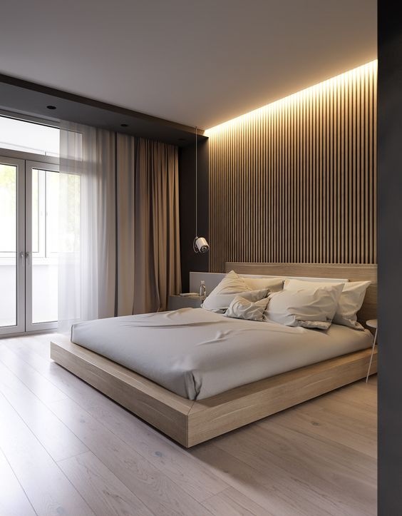 a beautiful minimalist bedroom with a relaxing feel, a wooden slab accent wall, a light-stained bed with neutral bedding, pendant lamps and neutral curtains