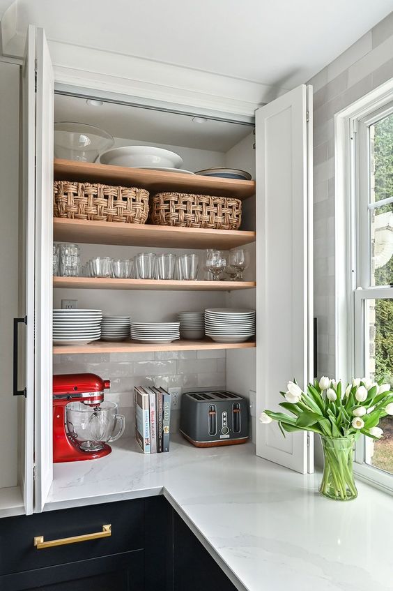 a cabinet with folding doors and open shelving inside, with appliances is a smart idea and folding doors don't steal your space