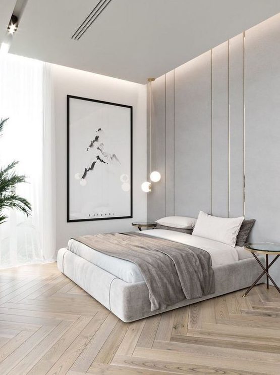 a chic minimalist bedroom in neutrals, with built in lights, a statement artwork, pendant lamps and potted plants