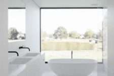 an all-white bathroom design with a view
