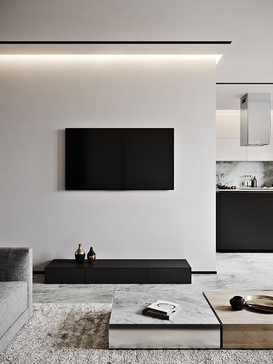 a contrasting living room in off-white and black, laconic coffee tables, a textural rug and built-in lights