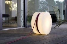 a cool modern outdoor lamp shaped as a roll with cords is a lovely idea for both indoors and outdoors and it looks awesome
