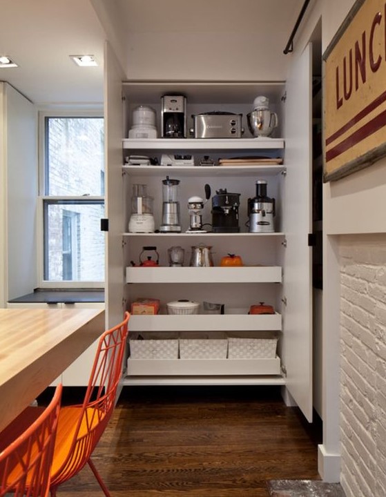 a large storage unit with shelves and drawers, with various appliances and other stuff is a cool idea to hide everything