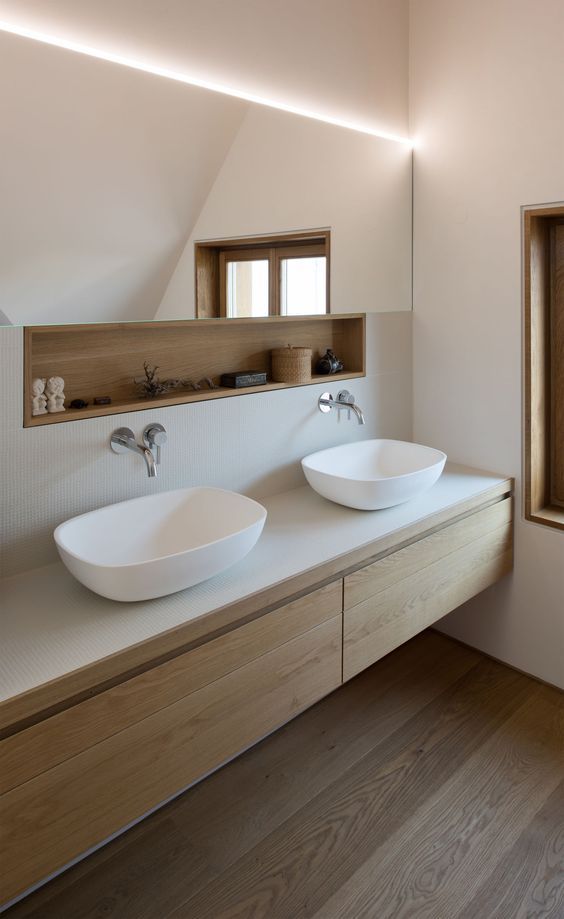 a long and narrow mirror with an additional built-in open shelf is a cool and simple way to keep your minimalist bathroom sleek