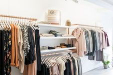 a minimalist closet done of copper holders for hangers and some open shelving is a cool idea to try