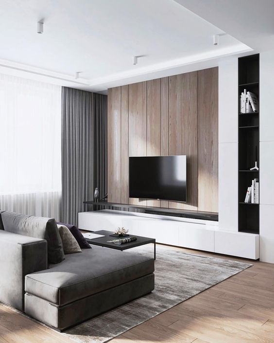 a minimalist living room with a wooden wall, grey curtains, a sofa and a rug plus touches of black here and there
