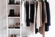 a minimalist makeshift closet with shoe shelves, a box and some space for clothes hangers