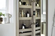 a mirror cabinet with a door that features a lot of storage space and lights is a super functional idea for a bathroom