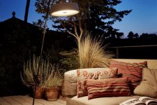 a modern and edgy interpretation of a floor lamp is a cool idea for a terrace, your outdoors will feel more secluded