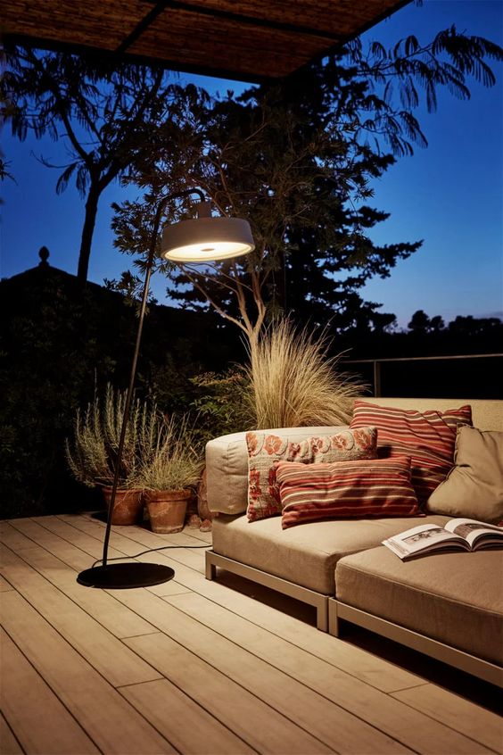 a modern and edgy interpretation of a floor lamp is a cool idea for a terrace, your outdoors will feel more secluded