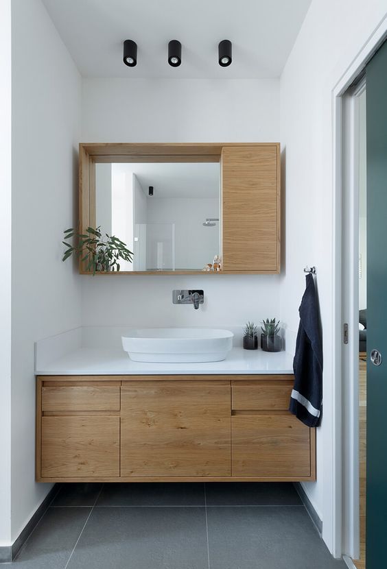 a modern mirror with an open shelf and a small storage cabinet attached to it is a lovely idea for a mid-century modern bathroom