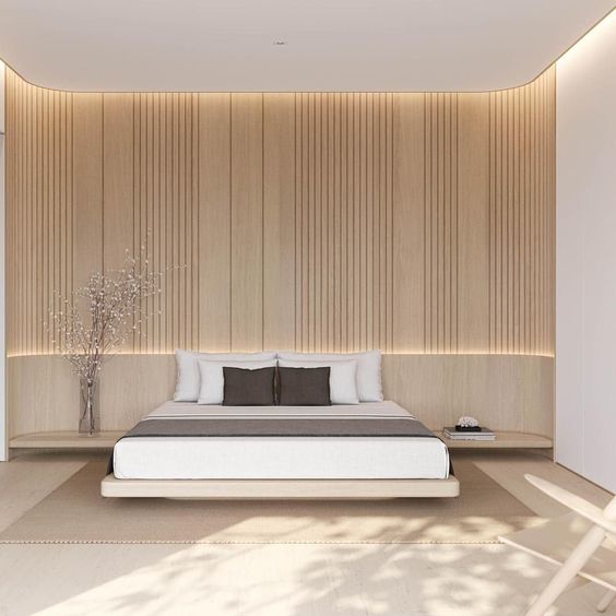a neutral minimalist bedroom with a light-stained slab wall, a floating bed and nightstands, built-in lights is cool