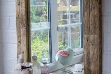 a reclaimed wood frame mirror with a mini storage shelf is a lovely idea for a rustic bathroom, it will add a cozy touch to your bathing space