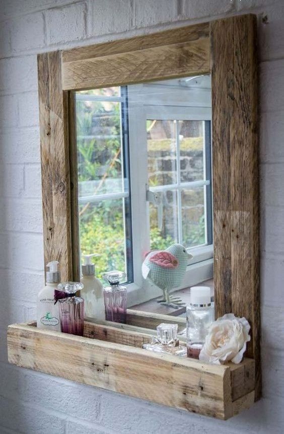 a reclaimed wood frame mirror with a mini storage shelf is a lovely idea for a rustic bathroom, it will add a cozy touch to your bathing space