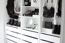 a simple and minimalist closet with holders for clothes and bags, with drawers and open shelves for various stuff