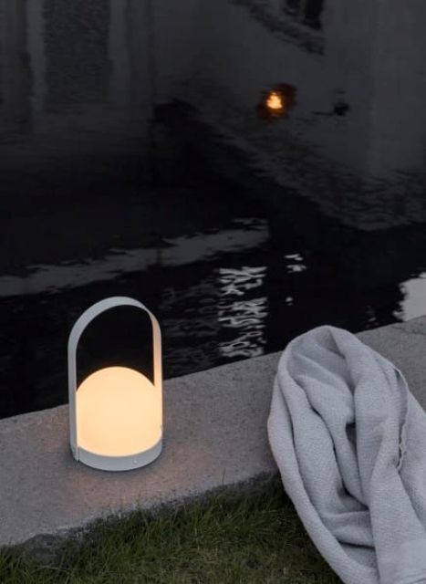 a small and laconic outdoor lamp with a handle is a pretty and mobile solution that can be taken indoors anytime