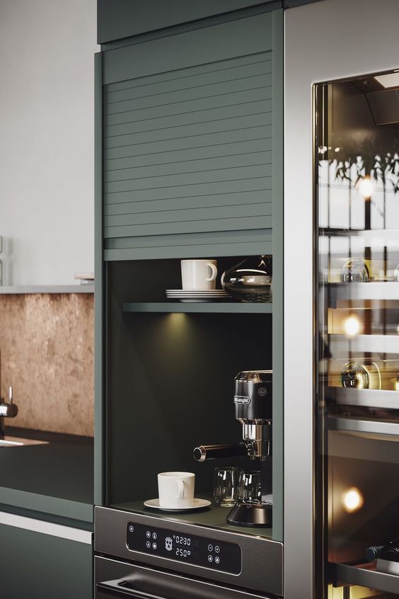 a small built-in cabinet with a garage door and lights, with a coffee matching and some mugs is a home bar hidden