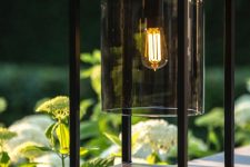a stylish modern black table lamp of metal and dark glass is a lovely idea for both indoors and outdoors