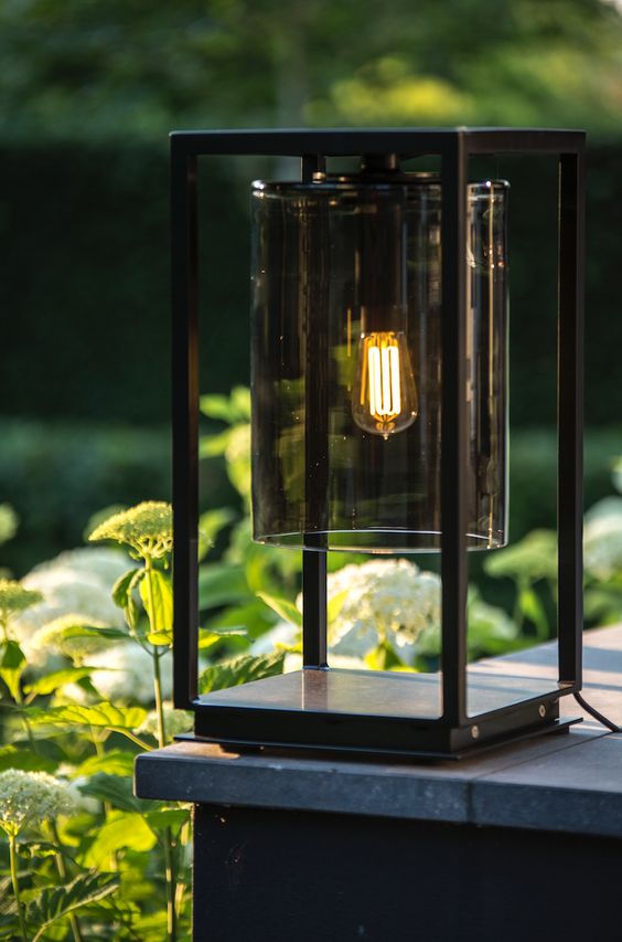 a stylish modern black table lamp of metal and dark glass is a lovely idea for both indoors and outdoors