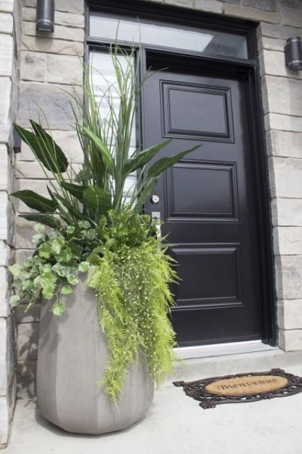 a tall concrete faceted planter with plenty of greenery is a gorgeous solution for a modern space