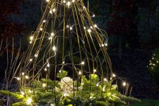 a trellis structure with string lights and evergreens is a catchy and simple rustic outdoor decor idea