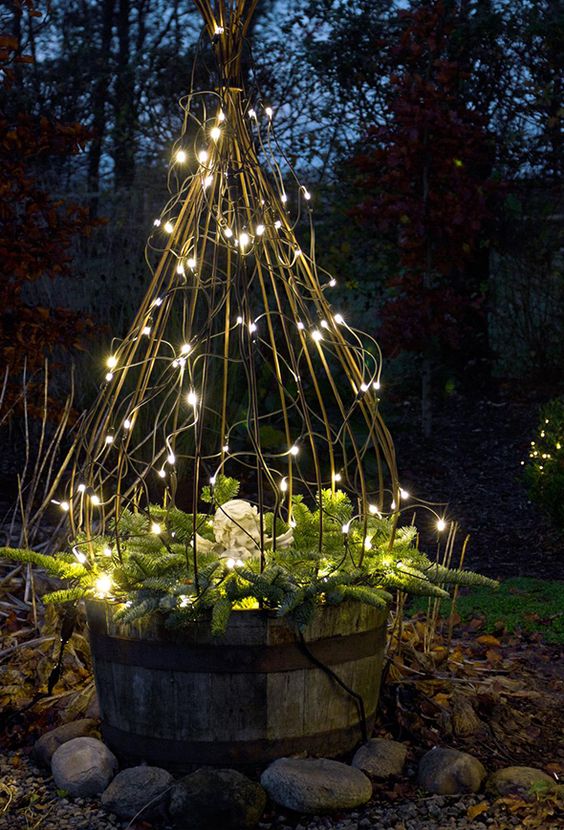 a trellis structure with string lights and evergreens is a catchy and simple rustic outdoor decor idea