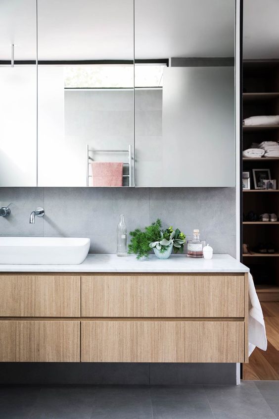 an oversized mirror storage cabinet is a smart solution to keep your minimalist bathroom sleek and neat and not to clutter it
