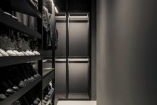 an ultra-minimalist black and graphite grey closet with lots of shoe shelves and some drawers plus holders for hangers