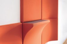 bold orange acousitc panels and a panel with an additional shelf is a very functional idea