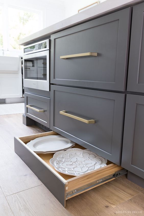 graphite grey cabinets featuring usual and low drawers is a cool idea for a modern space, put some dishes or lids into lower drawers