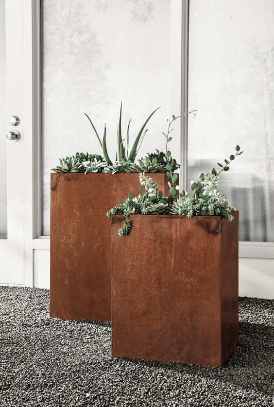 modern tall rusted metal planters will give a cool texture and color to the space and if you plant greenery, they will stand out