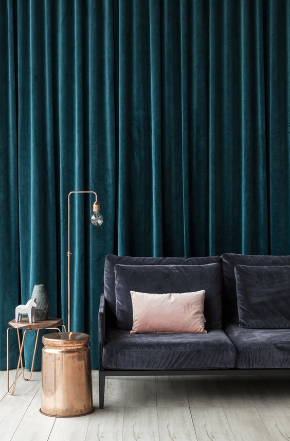thick velvet drapes will not only keep the sound but also cold away