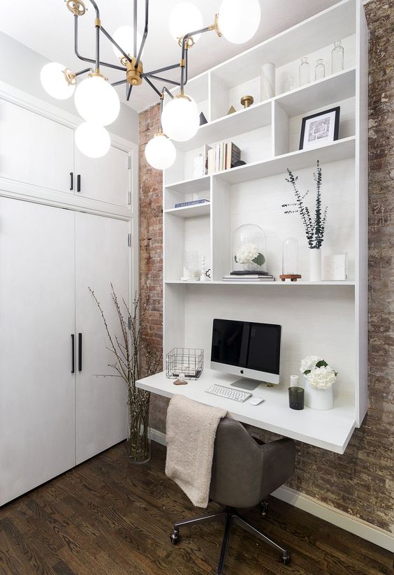 a contemporary white wall storage unit with open shelves and a desk at its end is a fresh idea of a small working space