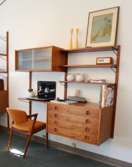 a rich-stained mid-century modern storage unit with open shelves and drawers and a small desk part is very functional