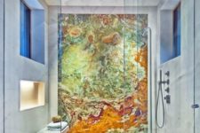 a spa-like shower space accented with a colorful geode statement wall that makes the shower even more gorgeous