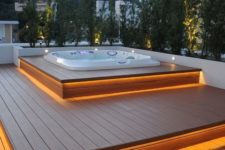 a step deck with each step illuminated and a sunken jacuzzi on top will let you enjoy relaxation, and greenery will hide you