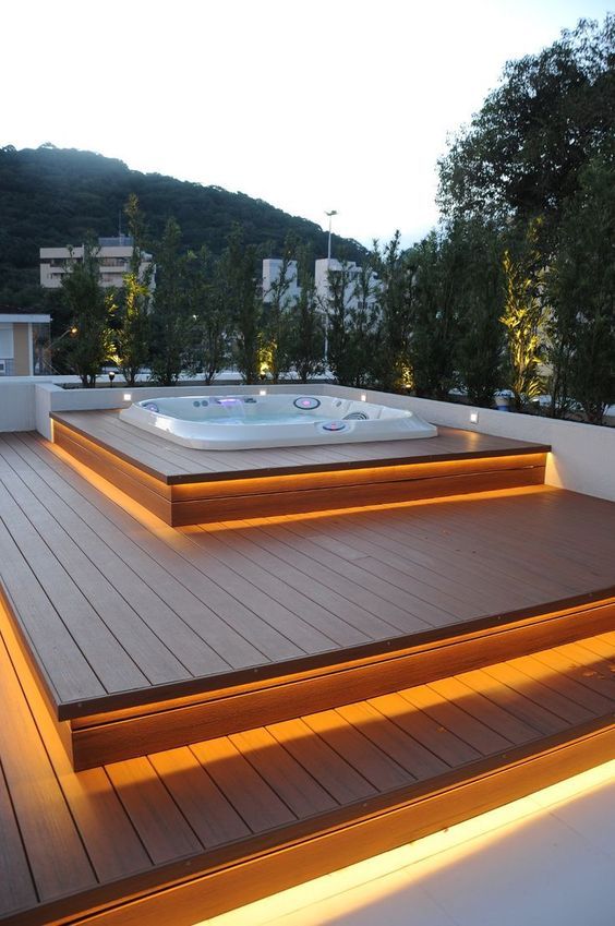 a step deck with each step illuminated and a sunken jacuzzi on top will let you enjoy relaxation, and greenery will hide you