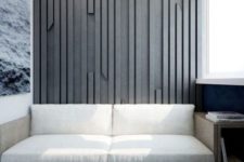 a textural accent wall done with wooden slabs attach to a plywood sheet and painted in an elegant grey shade